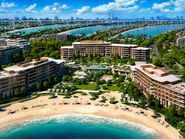 A high-resolution aerial view of a luxury beachfront residential and resort development surrounded by lush landscaping and turquoise waterways. Several modern mid-rise buildings frame a private sandy beach and landscaped central courtyard with pools, pathways, and recreational areas. In the background, palm-shaped island fronds extend into the sea, with rows of waterfront villas and a distant city skyline visible under a bright blue sky with scatte