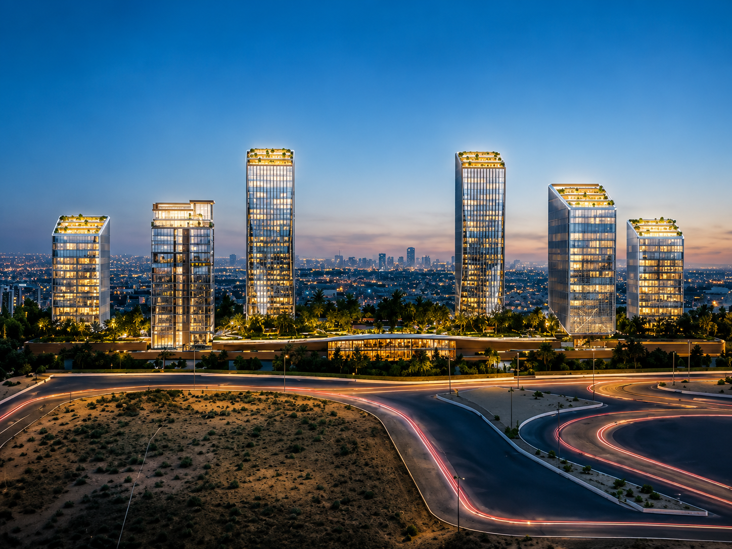 A high-quality dusk rendering of a contemporary mixed-use development featuring six modern glass towers with illuminated rooftop terraces and warm interior lighting. The buildings are arranged across a landscaped podium surrounded by palm trees and greenery. In the foreground, a curved multi-lane road creates light trails from passing vehicles, while a distant city skyline sits beneath a clear blue evening sky. The architecture emphasizes clean lines, floor-to-ceiling glass facades, and a premium urban design, conveying a luxury residential and commercial destination.